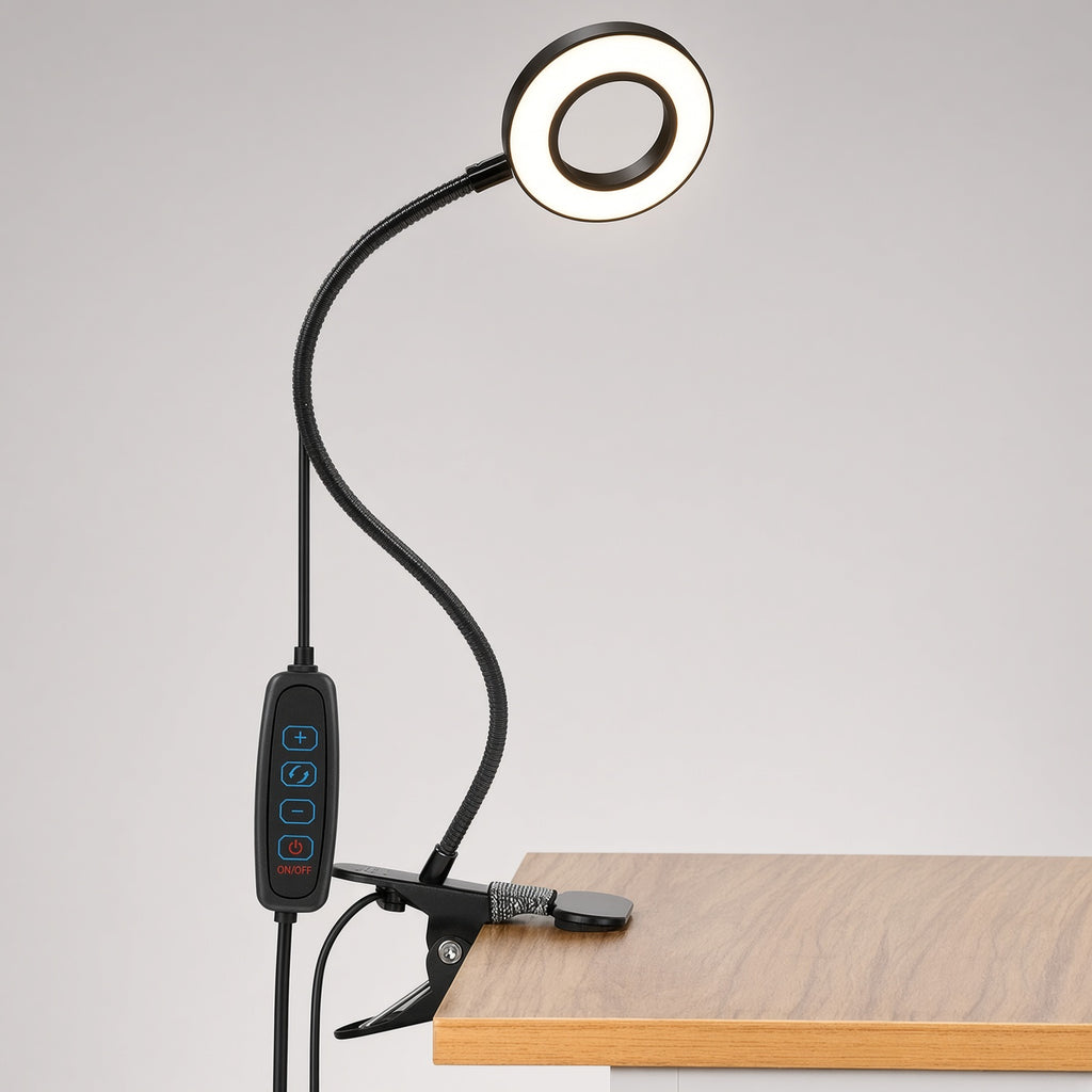Black USB clip-on ring desk lamp clamped to a desk edge, with inline remote for brightness, color mode and power